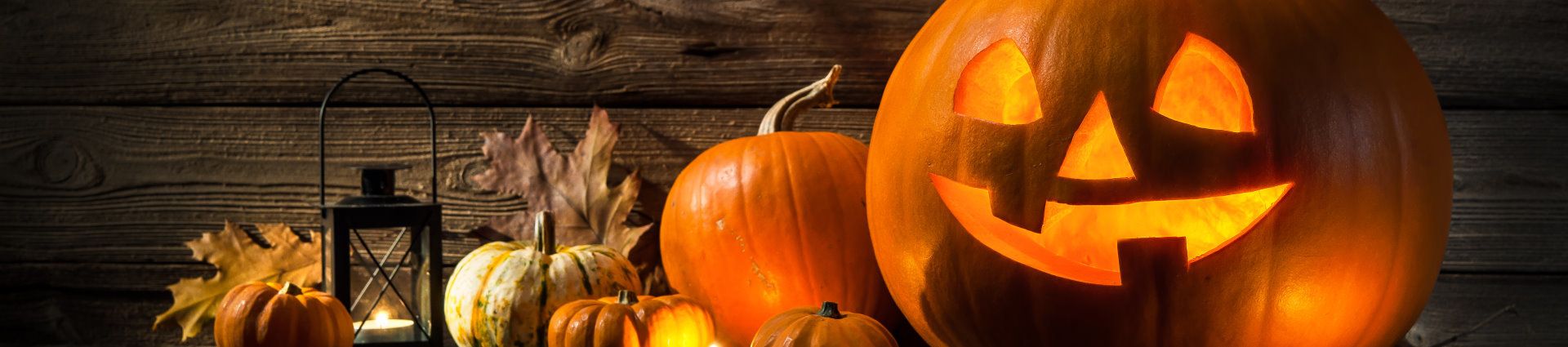 Halloween pumpkin head jack lantern on wooden background